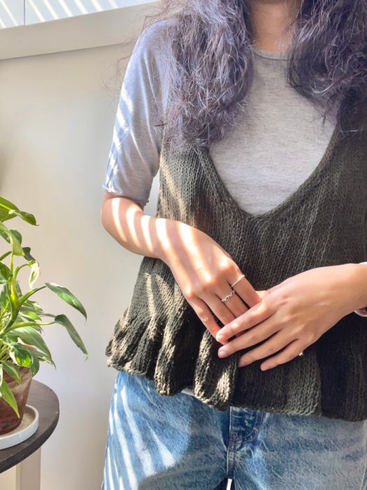 Wearing Frills V-Neck Tank Top, green ramie cotton knit layered over gray T-shirt with denim jeans