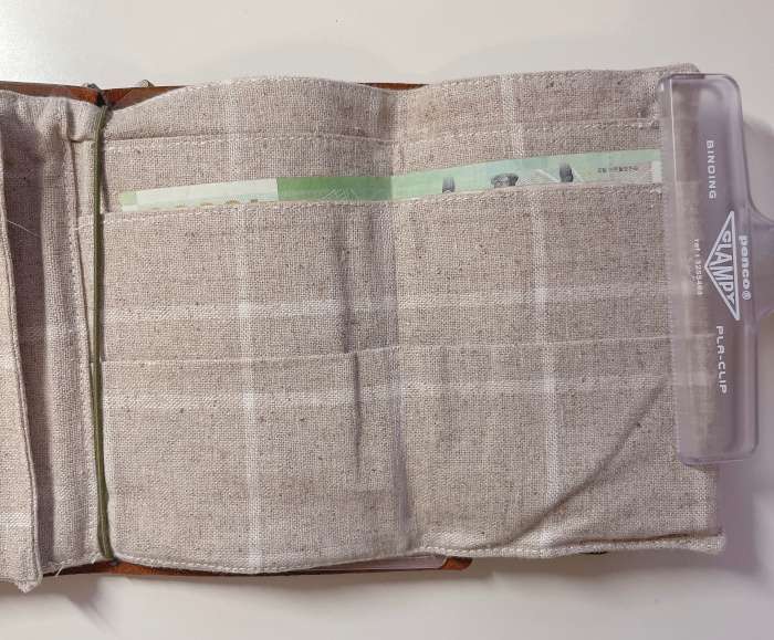 Open Traveler’s Notebook passport wallet with bills inserted