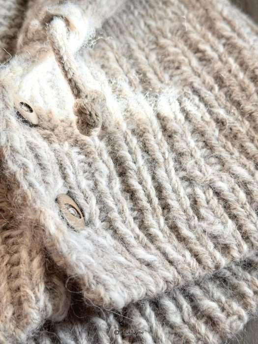 Close-up of balaclava stitches and cast-on edge, showing aran yarn structure