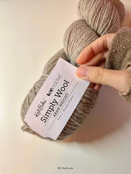 Close-up of KnitPicks Simply Wool Aran yarn skein with label