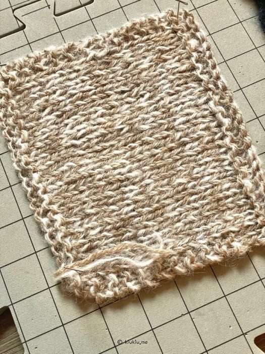 Knitting gauge swatch for balaclava made with aran-weight yarn